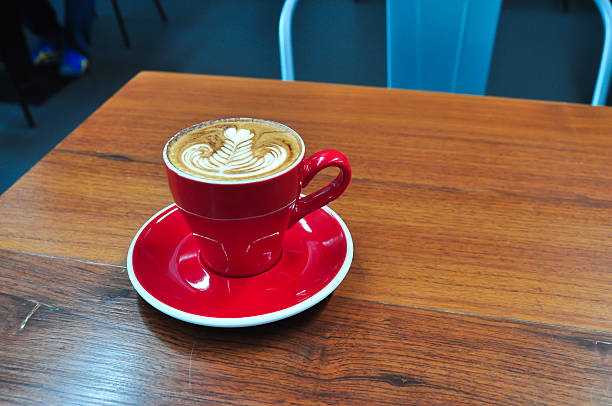 istock red Cup of coffee on a wooden table 621487244