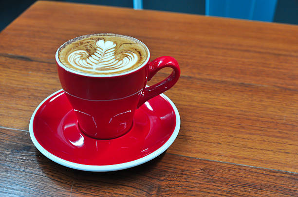 istock red Cup of coffee on a wooden table 621487330