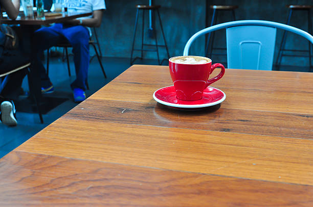 istock red Cup of coffee on a wooden table 621487364