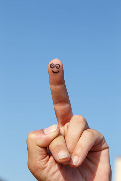 istock painted finger smile with sky at background 621487382