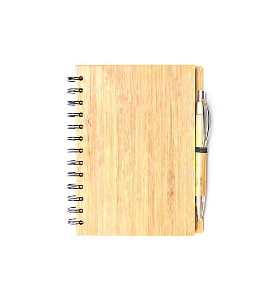 istock Closeup wooden note book with pen isolated on white background 621487842