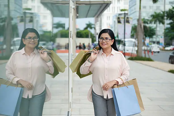 Portrait of senior Asian woman enjoying shopping