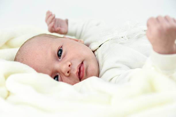 istock baby lying on a bed with towel 621489094