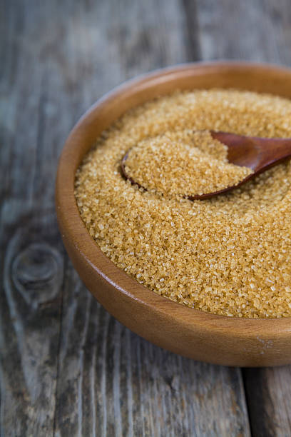 istock Sugar and spoon in a wooden bowl 621489272