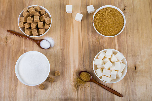 istock Cane and white sugar in a white bowls 621490930