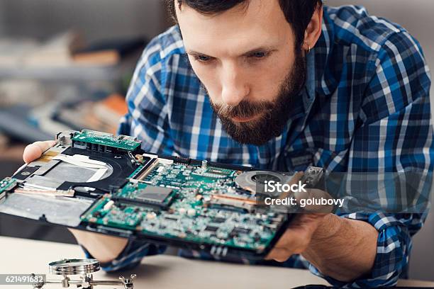Engineer Studying Computer Motherboard Closeup Stock Photo - Download Image Now - Computer, Recycling, Computer Part
