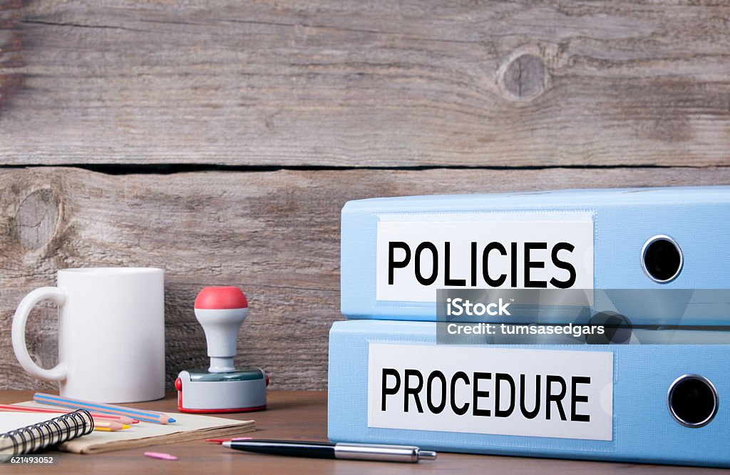Policies and Procedure. Two binders on desk Policies and Procedure. Two binders on desk in the office. Business background. Strategy Stock Photo