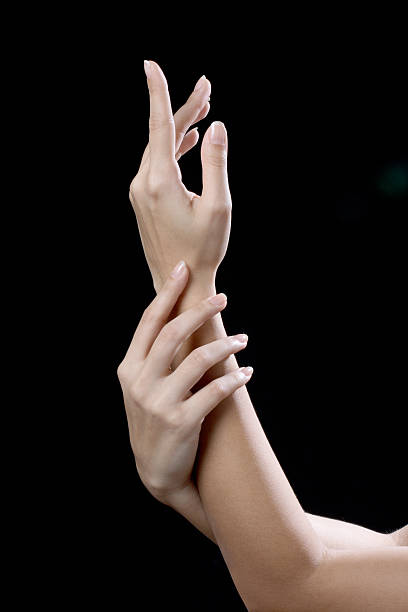 istock beautiful young hands woman isolated on black background 621494904
