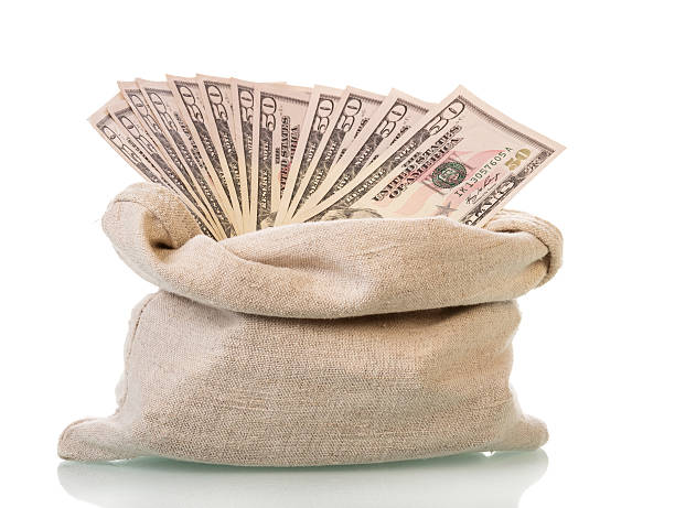 istock Dollar bills in bag isolated on white background. 621496778
