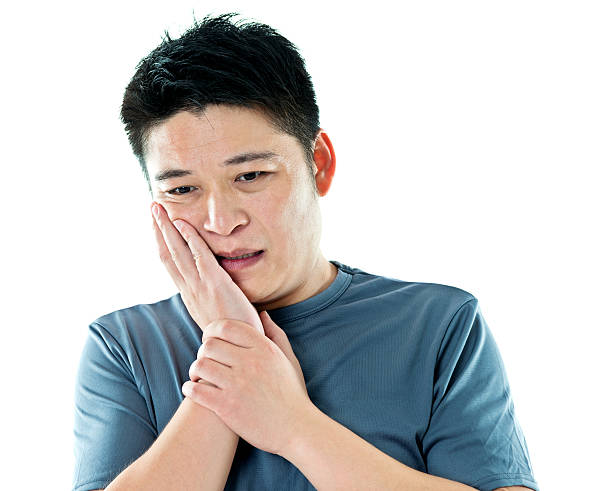 istock Young asian man suffering from toothache 621496808