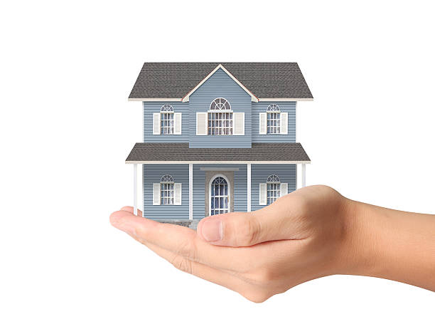 istock Mortgage concept by house from hand 621497740