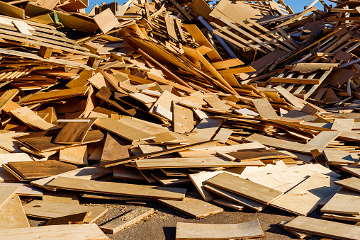 Pile of wooden debris in industrial area. The wood is later shredded to be used as fuel.