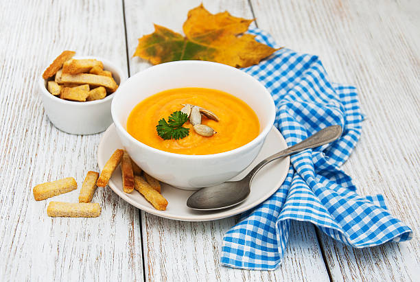 istock Pumpkin soup with fresh pumpkins 621499038