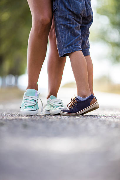 istock Unrecognizable mother and son standing at the park. 621499356
