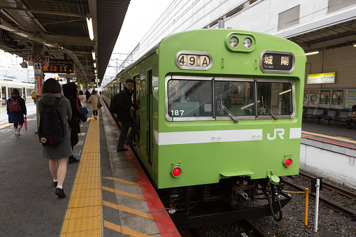 Kyoto, Japan - December 21, 2015 : Passengers at Kyoto Station in Kyoto, Japan. This Nara Line Train is going to Joyo Station. It is operated by the JR West.