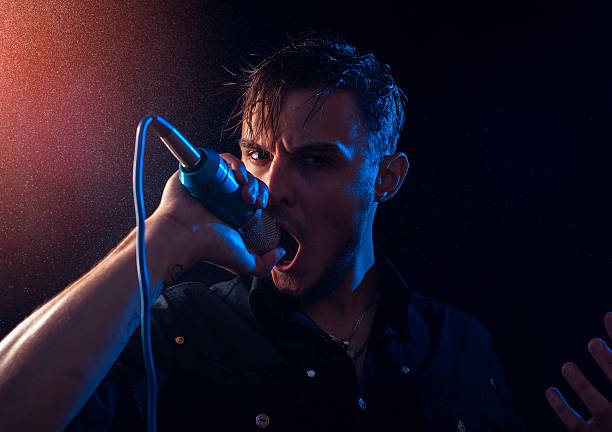 istock Cute emotional singer with microphone on the stage 621500466