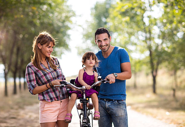istock Happy family with bicycle spending day in nature. 621500886