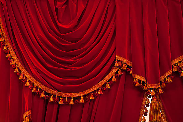 istock Open red curtains with glitter opera or theater background 621501384