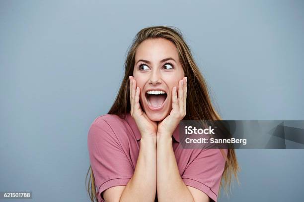 Surprised And Ecstatic Woman In Pink Studio Shot Stock Photo - Download Image Now - Head In Hands, People, Colored Background