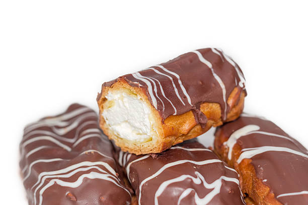 istock Eclairs with whipped cream and chocolate icing closeup 621501928