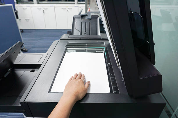 istock businesswoman place paper sheet on printer plate 621502364