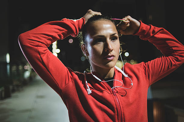 istock Beautiful athlete tying her hair before exercise 621503610