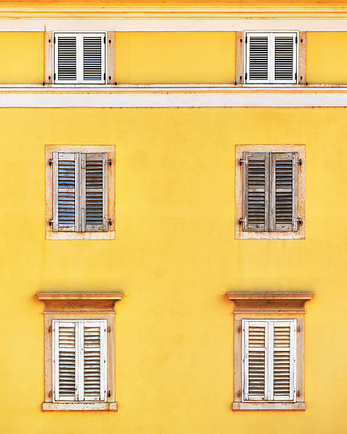 istock Building facade and old windows with classic wooden shutters bli 621505646