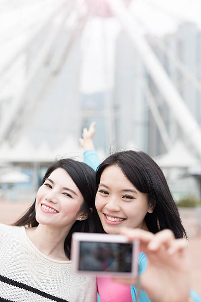 istock two woman selfie in hongkong 621505998