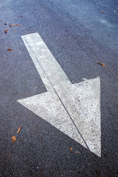 istock White arrow on asphalt road, traffic sign 621506212