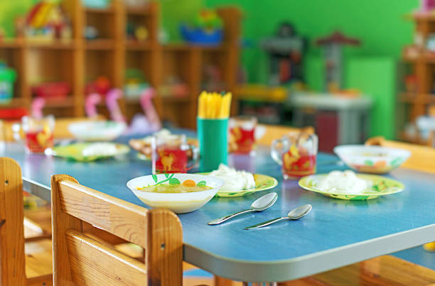 Meal time in kindergarten. stock photo