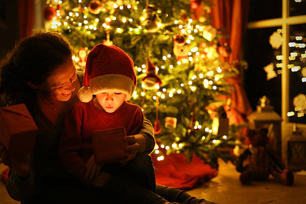 istock Mother and Child Opening a Christmas Present Together 621506672