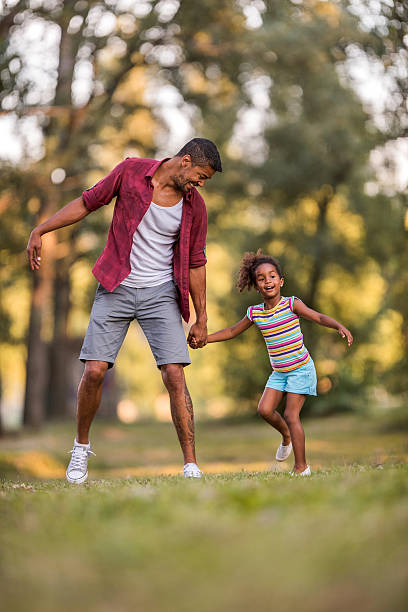 istock Happy father and daughter having fun in the park. 621506992