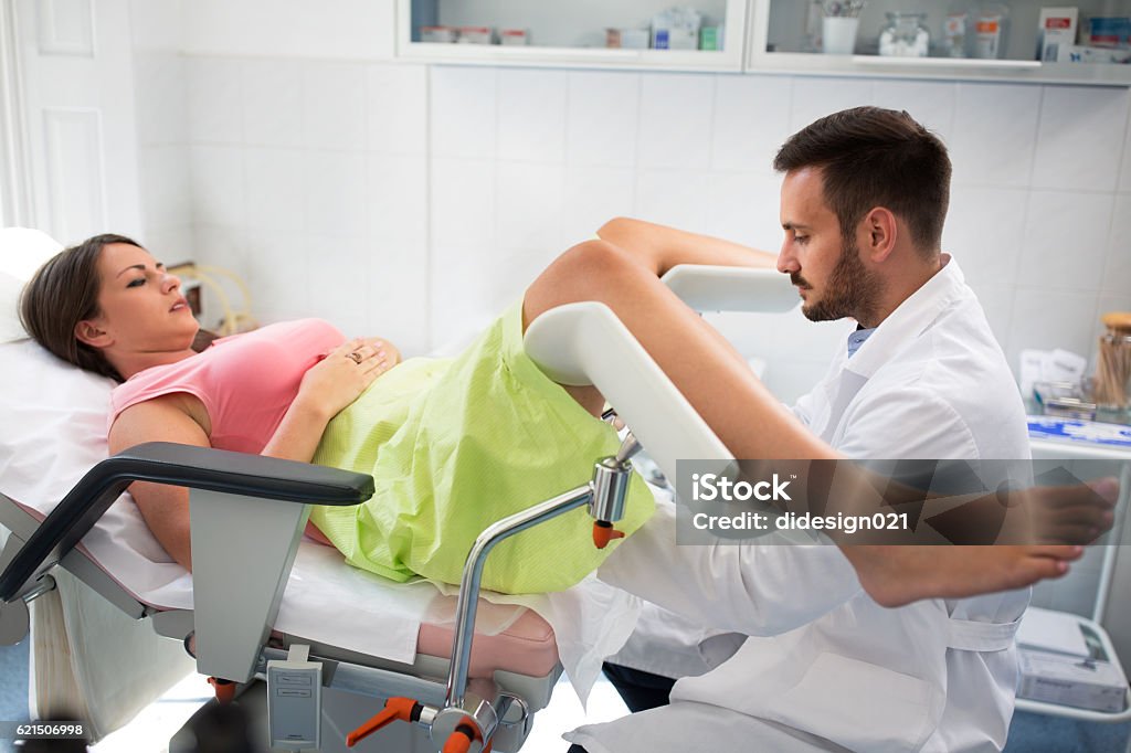 Gynecologist clinic examination Beautiful young woman lying in gynecology clinic doing examination Gynecological Examination Stock Photo