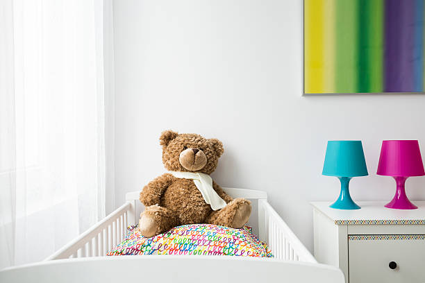 istock Child room with a cradle and teddy bear 621508154