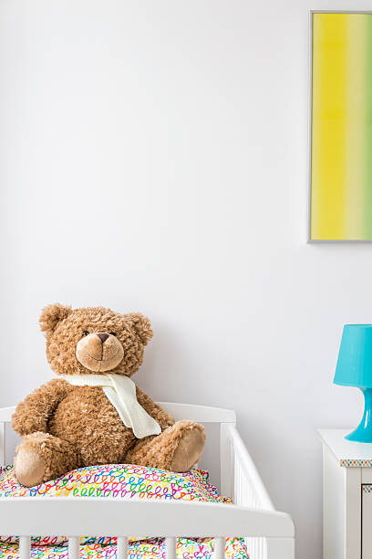 istock Sweet teddy bear in a cradle 621508218