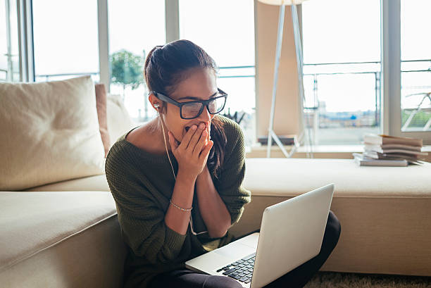 exited and cheerfull woman using her laptop