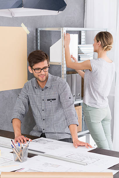 istock Man is looking at papers on desk 621569278