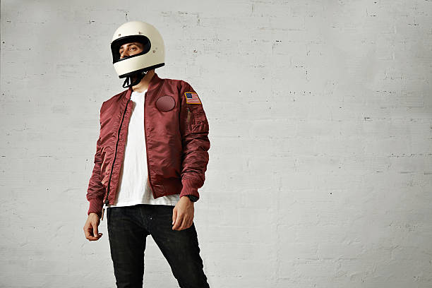 istock Man in a bordeaux pilot jacket with helmet 621569672