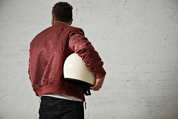istock Man in a bordeaux pilot jacket with helmet 621569924