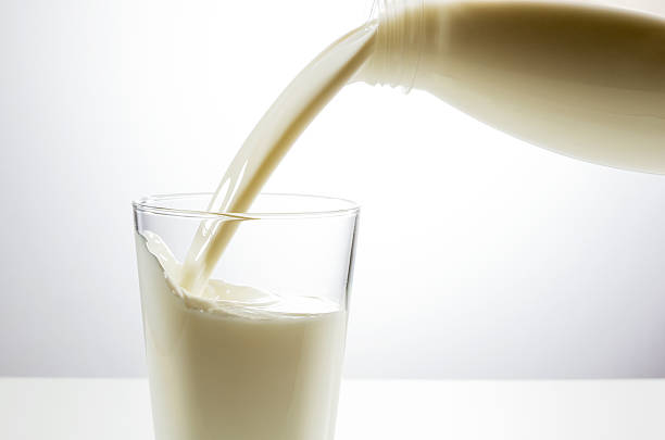 istock Pouring a glass of milk from bottle 621569976
