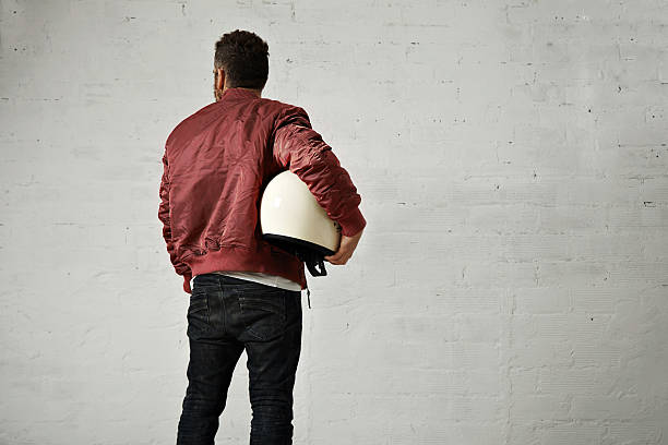 istock Man in a bordeaux pilot jacket with helmet 621569988