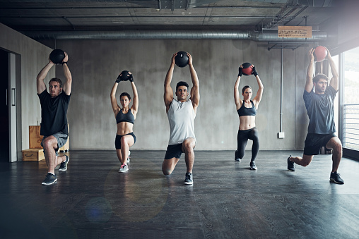 Shot of a fitness group having a workout session at the gym