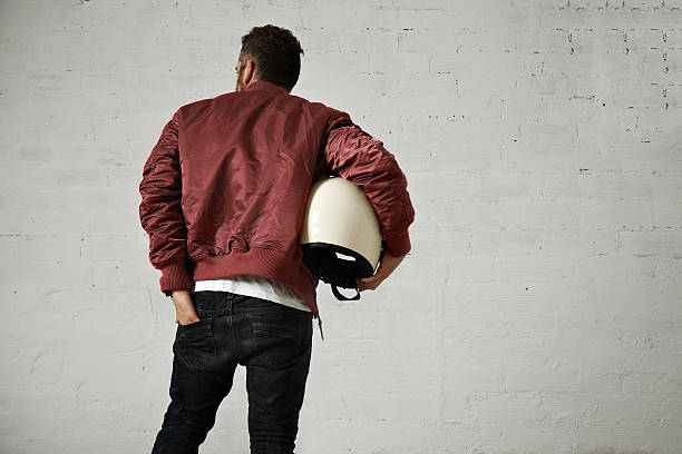istock Man in a bordeaux pilot jacket with helmet 621570054