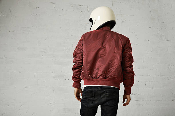 istock Man in a bordeaux pilot jacket with helmet 621570116
