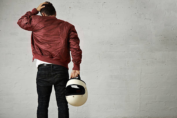istock Man in a bordeaux pilot jacket with helmet 621570448