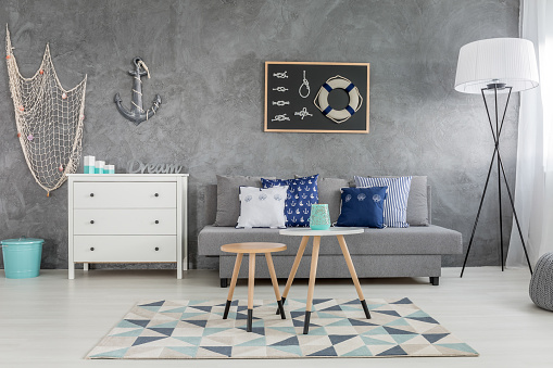 Modern grey living room with nautical decorations and decorative wall finish
