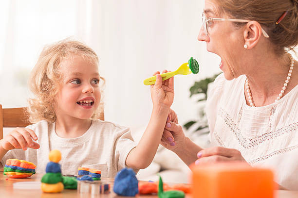 istock Girl playing with grandmother 621571068