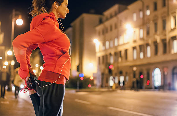 istock Female Athlete Warming up for a Late Night Jogging 621571248