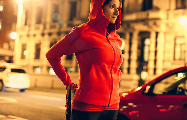 istock Female Athlete Warming up for a Late Night Jogging 621571340