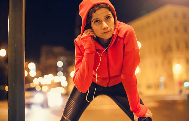 istock Female Athlete Preparing Herself for a Late Night Jogging 621571362